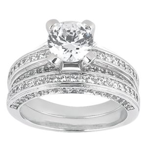 A silver engagement ring set features a large central gemstone surrounded by smaller stones on a multi-band design.