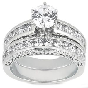 A silver ring set featuring a large central round stone surrounded by smaller stones along the band.