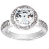 A silver ring features a large round diamond at the center, surrounded by smaller diamonds on the band.