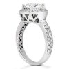 A silver engagement ring with a large center stone and smaller diamonds set along the band.