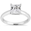 A silver engagement ring featuring a large, clear, square-cut center stone.
