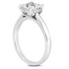 A silver engagement ring with a large, round diamond sits atop a smooth band.