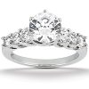 A silver ring with a large central diamond and four smaller diamonds on either side.