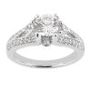 A silver engagement ring with a large round center diamond and smaller diamonds on either side.