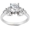 A silver ring with a central round diamond surrounded by smaller diamonds.