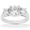 A silver three-stone ring featuring a large central round diamond flanked by two smaller round diamonds.