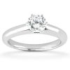 A silver engagement ring with a round diamond sitting prominently on top.