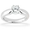 A platinum engagement ring features a round diamond setting prominently displayed.