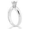 A silver ring with a prominent diamond setting is positioned upright on a white background.