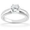 A silver engagement ring featuring a large round diamond on a polished band.