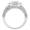 A white gold ring features a central round gemstone surrounded by smaller diamonds, highlighting its intricate design.