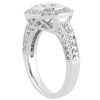 A silver ring featuring a prominent round diamond center stone and intricate band detailing.