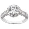 A round, silver engagement ring with a central diamond surrounded by smaller diamonds on the band.