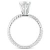 A silver engagement ring with a round band and a large diamond at the top.