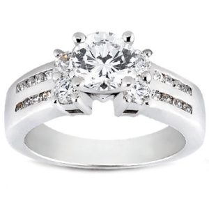 A silver engagement ring features a large round diamond surrounded by smaller diamonds on each side.