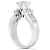 Silver engagement ring featuring a large central diamond and two smaller diamonds, displayed at an angle to highlight its setting.
