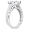 A silver engagement ring featuring a large, round-cut diamond mounted on a four-prong setting.