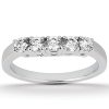A five-stone silver ring is displayed prominently with clear, sparkling gemstones set in a row.