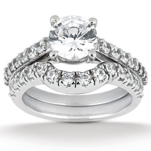 A diamond engagement ring with a large round stone and a split band adorned with smaller diamonds is displayed.