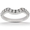 A silver ring features a curved row of sparkling diamonds along its band.