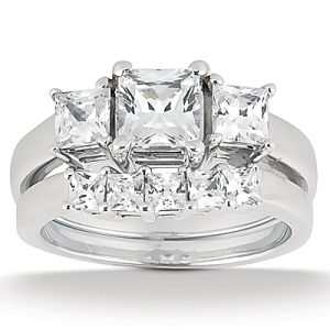 A silver ring featuring multiple sparkling, rectangular cut gemstones.