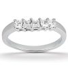 A silver ring with four clear rectangular stones set in a row on the band.