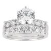 A silver engagement ring set featuring a large round center diamond and a pave band with multiple smaller diamonds.