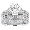 A silver engagement ring set featuring a large central diamond surrounded by smaller stones on the band.