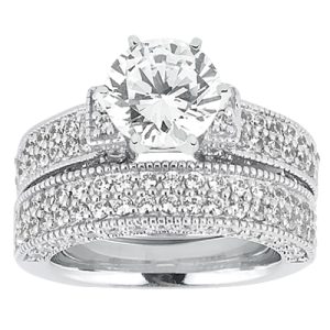 A silver engagement ring set featuring a large central diamond surrounded by smaller stones on the band.
