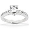 A silver engagement ring with a large central diamond and smaller diamonds set along the band.