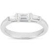 A silver ring featuring three clear, rectangular gemstones is displayed prominently.