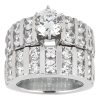 An engagement ring with a large central diamond surrounded by smaller diamonds set in a silver band.