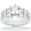 A silver engagement ring featuring a large round center stone and multiple smaller accent stones on either side.