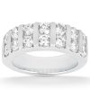 Band-style ring with multiple round, clear gemstones set in a polished metal band.