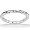 A silver band ring is displayed, featuring a row of small, sparkling diamonds along its surface.