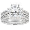 A multi-stone engagement ring featuring a central round diamond surrounded by smaller diamonds on a silver band.