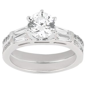 A silver engagement ring featuring a large round diamond at the center flanked by smaller rectangular diamonds.