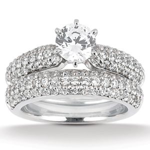 A diamond engagement ring with a round central stone and two intertwined bands set with small stones.