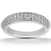 A silver band ring is displayed, featuring a row of sparkling gemstones along its surface.