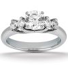 A silver engagement ring featuring a large central diamond flanked by two smaller diamonds on either side.