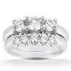 A silver engagement ring features a cluster of round, clear diamonds arranged prominently on the band.