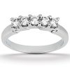 A silver ring featuring five clear gemstones arranged in a row.