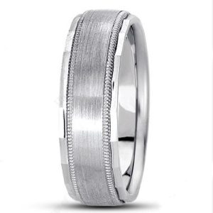 A silver wedding band with a brushed finish and decorative edges is displayed.