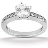 A diamond engagement ring with a round center stone and shimmering accents along the band.