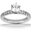 A silver engagement ring featuring a central round diamond surrounded by smaller diamonds on the band.