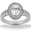 A silver engagement ring featuring an oval central diamond surrounded by smaller diamonds.