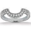 A silver wave-shaped ring is adorned with small clear gemstones.
