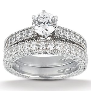 A silver engagement ring set featuring a large central diamond surrounded by smaller diamonds.
