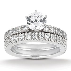 A silver wedding ring set featuring a central round diamond surrounded by smaller diamonds on both bands.