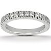 A silver band ring set with multiple round clear gemstones encircles the band.